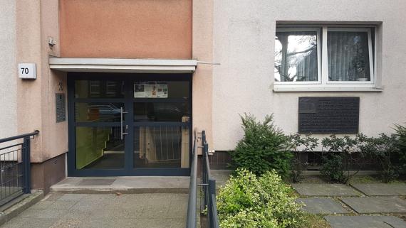 House entrance of a new building block with large dark green entrance door