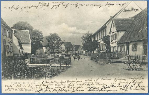 Historische Ansichtskarte von Oberdorf - Partie am Bach - Blick in die Straße mit dem Haus Löb Neumetzger, - versandt am 26. Juli 1904