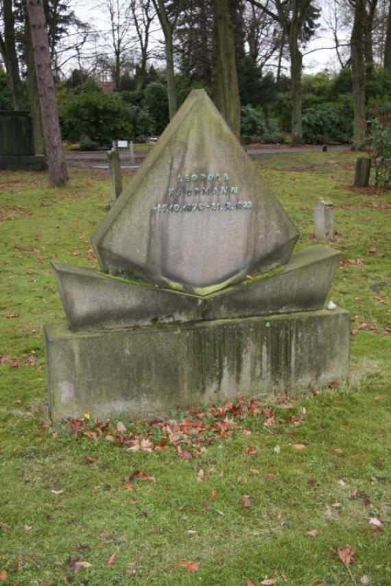 A single Jewish gravestone in a meadow.