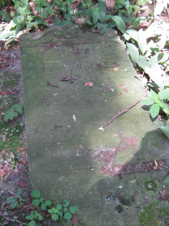 lying weathered gravestone