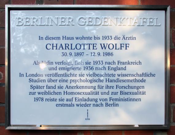 Auf dem Foto sieht man eine Gedenktafel, welches am ehemaligen Wohnort von Charlotte Wolff angehangen wurde. Auf dem Schild stehen einige Informationen zu Charlotte Wolffs Leben.