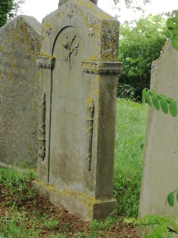 Detail of a gravestone on the right side of the road