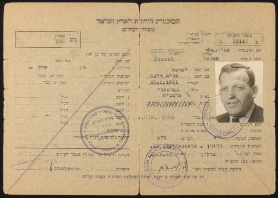 Certificate of the Jewish Agency for Palestine, folding card, with passport photo, front, typewritten, Hebrew, Berlin, Aug. 23, 1948.