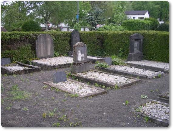 Several shallow graves in a corner of the Jewish cemetery