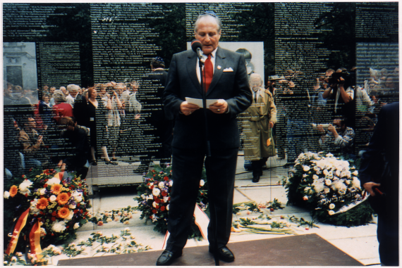 Alfred Silberstein gives a speech on the mirror wall.