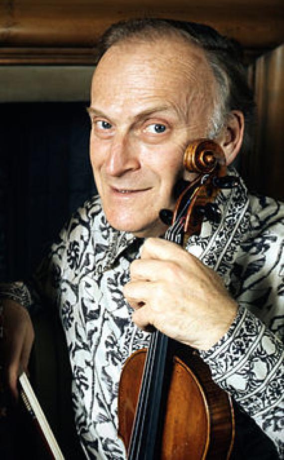 Portrait of Yehudi Menuhin with violin in hand.