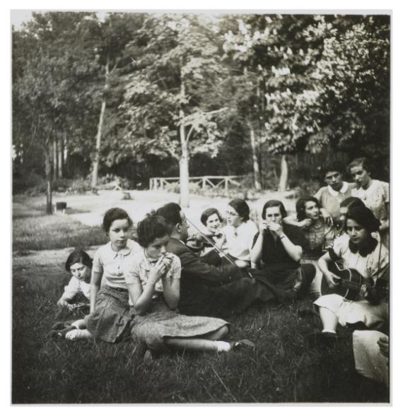 Erwin Zimet during a music lesson with the children of the Lehnitz Jewish Recreation Center. Music was an important part of the recreation center.