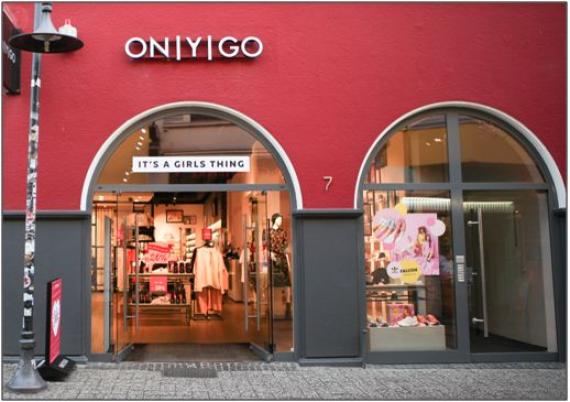 Aktuelle farbige Aufnahme des ehemaligen Geschäfts der Familie Landsberg in der Schüttingstraße 7. Die Schaufenster bestehen aus zwei Rundbögen. Heute befindet sich eine Modegeschäft in den Räumen.