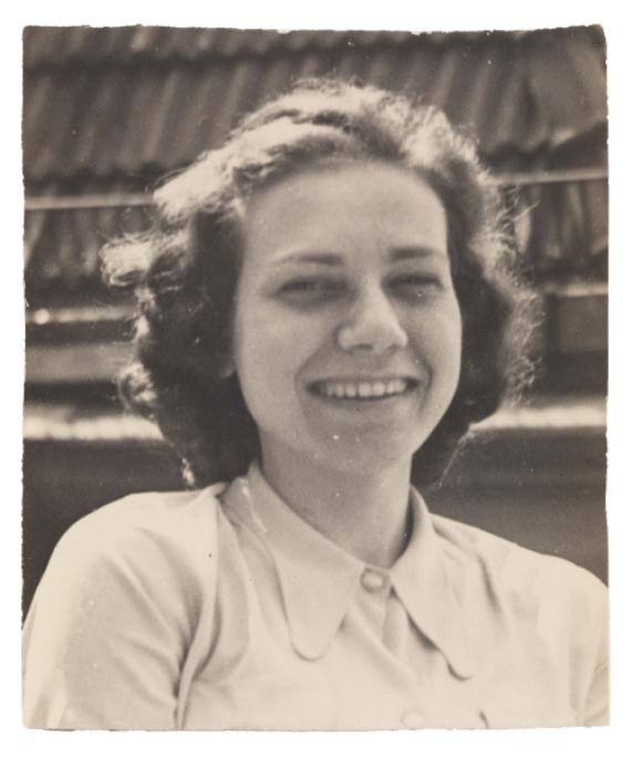 Felice Schragenheim in a bright blouse, she looks at the camera laughing