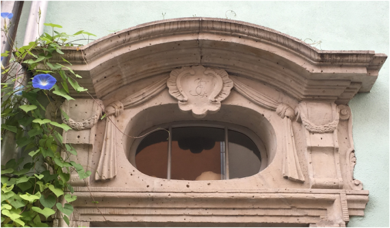 Portal above the entrance door with initials J.E. for Jacob Elkan