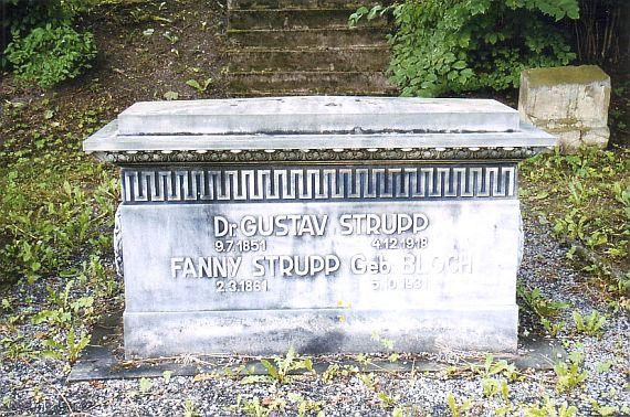 The tomb has the shape of a simple altar and is made of light stone