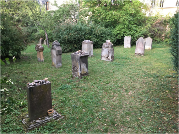 The memorial and gravestones in the Jewish cemetery