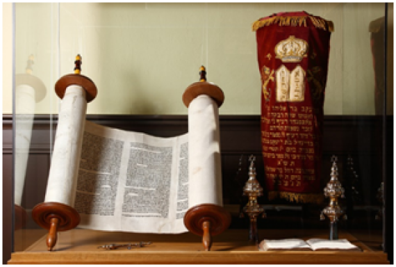 Torah scroll and other cult objects in a display case. The synagogue is no longer used for services