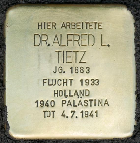 Golden stumbling stone with inscription.