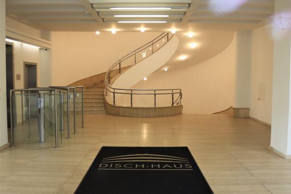 A bright entrance hall with spiral staircase.