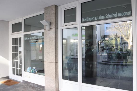 Large shop windows of a building and entrance.