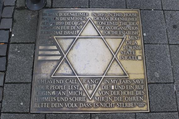 Metal plate with Star of David and inscription.