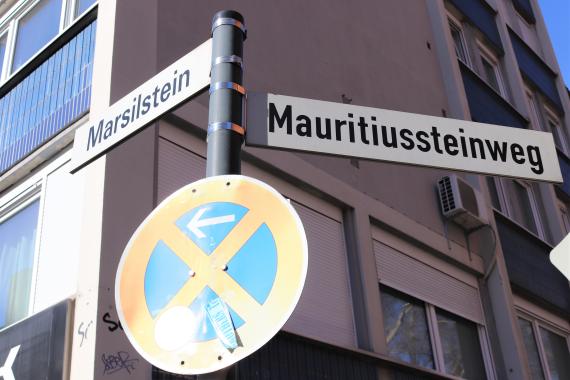 Metal bar with two street signs