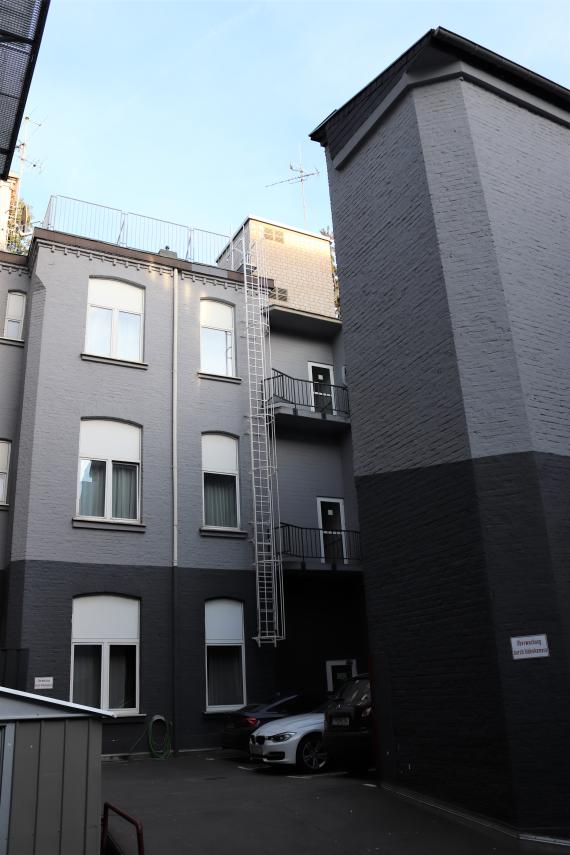 Photo of a backyard surrounded by buildings.