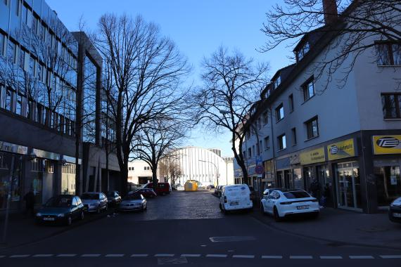 Photo of a street with cars and buildings.