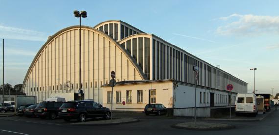 Large semicircular building with large windows.