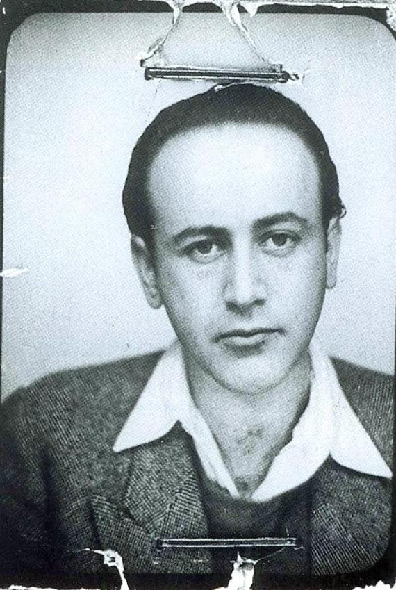 b/w passport photo, stapled with two clips, young man with high hairline