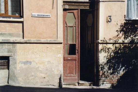 dilapidated house with high wooden door