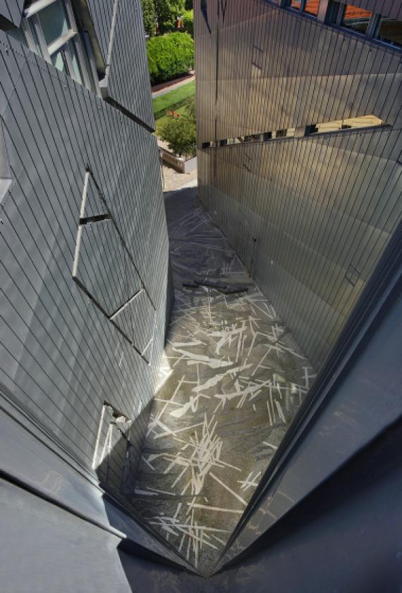 paved courtyard surrounded by galvanized walls