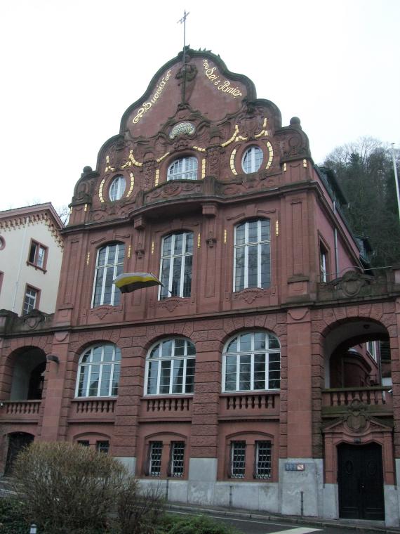 House with red facade and golden accents