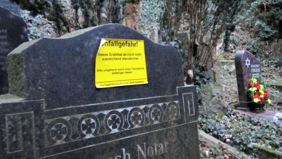 Gravestone with warning sign