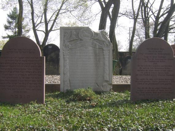 Three gravestones standing side by side