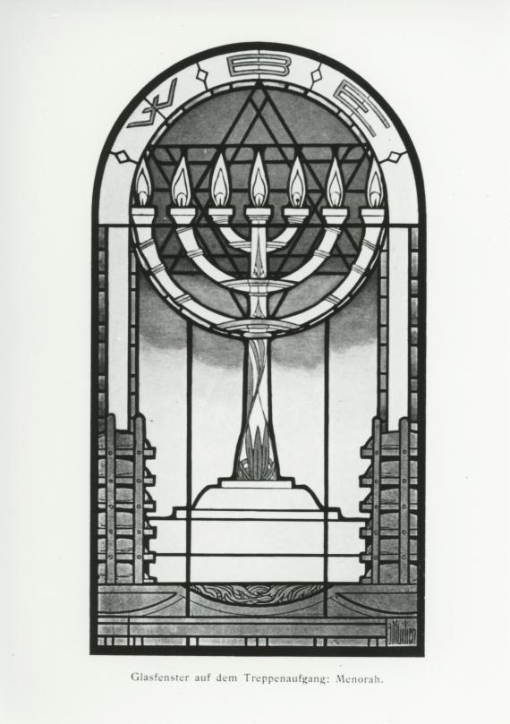 Stained glass window of the staircase in the lodge house, in the style of a mosaic. Motif: Menorah (seven-branched candlestick), all candles are lit. Behind the candlestick a Star of David. Above it in an oval three letters: W B E.