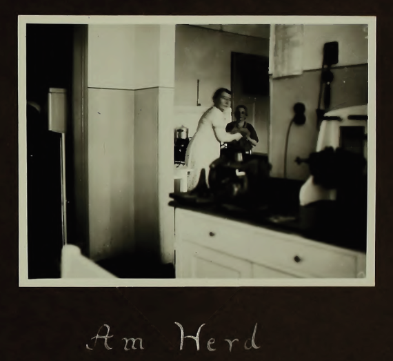 Two women are standing together behind a kitchen counter.