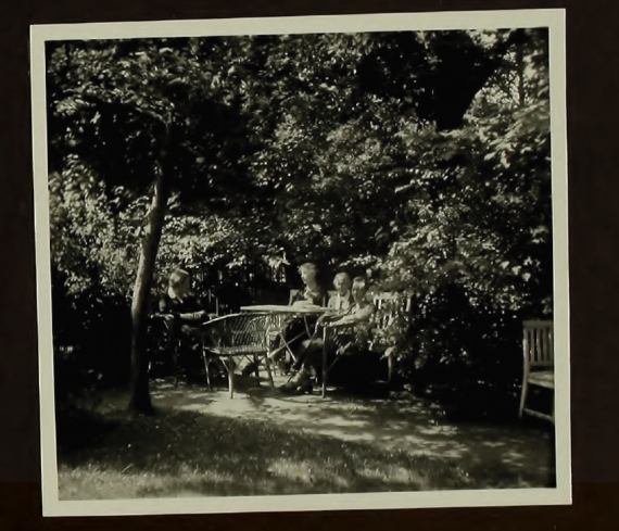 Four residents sit together among the trees.