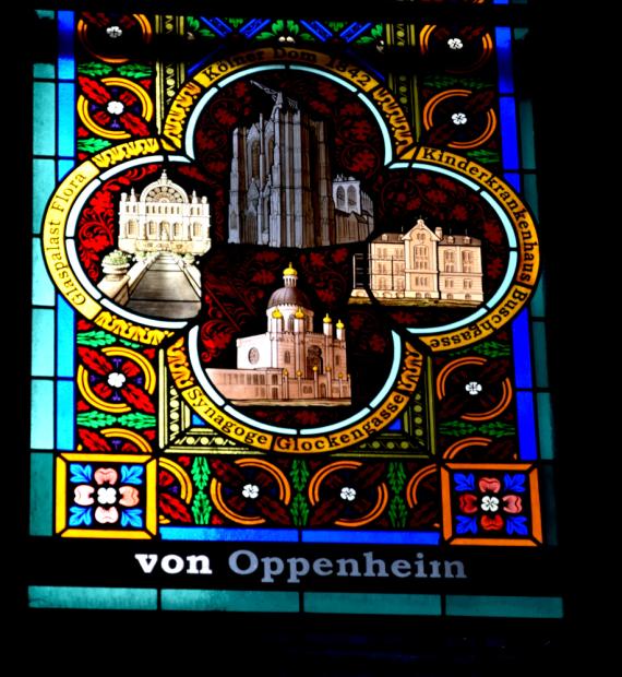 Detail of the Oppenheim family window donated in 2008. Illustrations of the donors' activities: Cologne Cathedral above, Children's Hospital on the right, Glockengasse Synagogue below and Kölner Flora on the left.