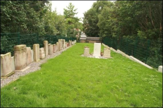 A meadow. On the left a row of gravestones.