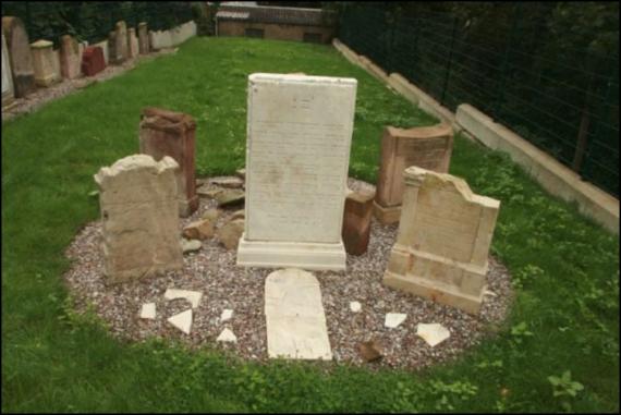 Gravestones arranged in a circular gravel bed