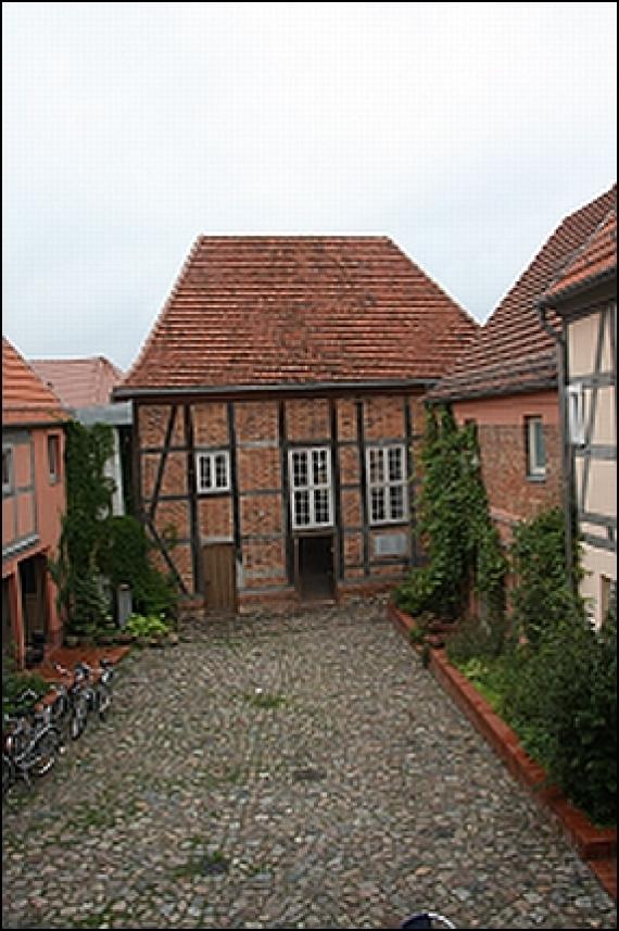 A brick building on a yard.