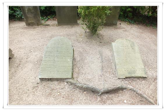 Two tombstones lie on the ground.