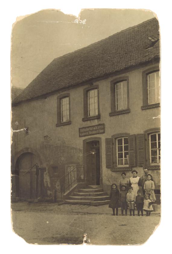 Picture of Roos family in front of their home with store