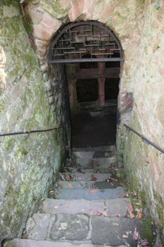 A steep staircase leads down to the first landing. This is secured with a mesh door