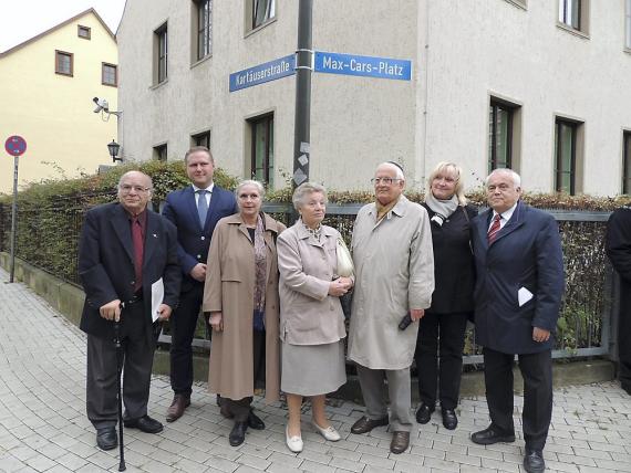 Group in front of street sign