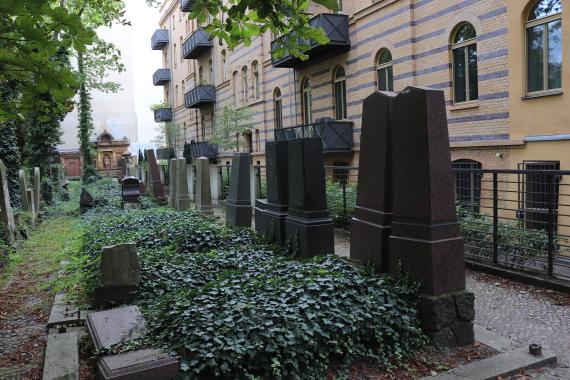 Part of the cemetery with residential building behind it