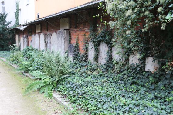 Part of the Jewish cemetery, gravestones on a brick wall