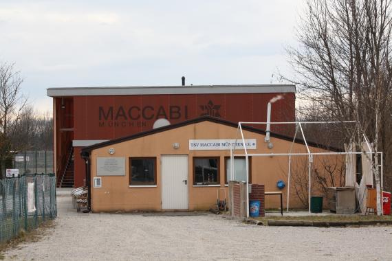 Forecourt. Behind it, a clubhouse at ground level. And behind it a higher clubhouse.  