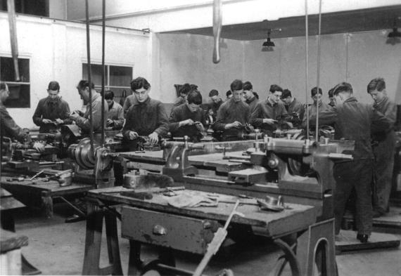 Apprentices working at workbenches in the Jewish training workshop