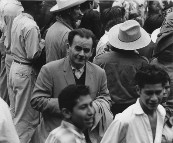 Bird's eye view of a crowd at a demonstration, with one person looking towards the camera