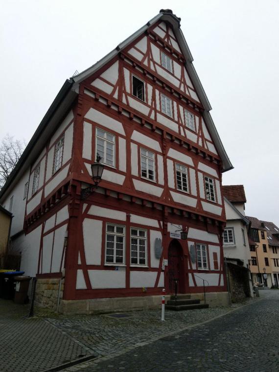 White and dark red half-timbered house.