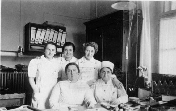 Five nurses can be seen in an office