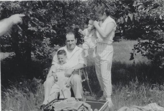 Schwarz-weißes Familienfoto auf einer Wiese unter Bäumen